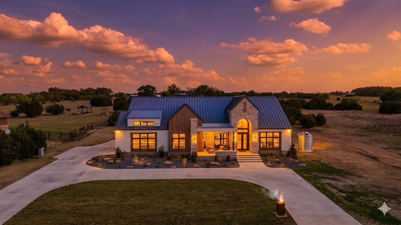 Hill Country estate at dusk beneath a dramatic sky