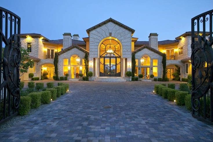 Grand gated Hill Country mansion at blue hour
